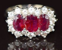 An 18ct white gold ring set with three oval cut rubies of approximately 0.8, 0.5 & 0.5ct