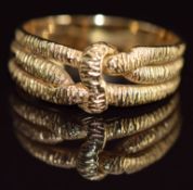 An 18ct gold love knot puzzle ring with engraved decoration, 4.6g, size P (has been permanently