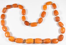 Baltic amber necklace made up of 28 barrel shaped beads, the smallest 19 x 14mm and largest 26 x