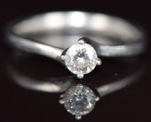 A platinum ring set with a round cut diamond of approximately 0.26ct, 3.5g, size K