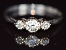 A platinum ring set with three diamonds, the centre diamond approximately 0.26ct, 2.7g, size S