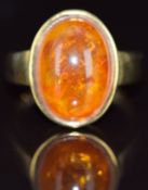 A 9ct gold ring set with a pressed amber cabochon, 4.4g, size L