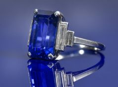 A platinum ring set with an emerald cut sapphire measuring 8.55ct and two baguette cut diamonds to