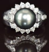 An 18k white gold ring set with a Tahitian pearl measuring approximately 10.5mm surrounded by