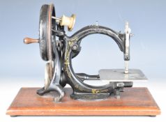 Wilcox and Gibbs hand sewing machine, on wooden base