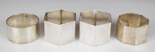 Four various hallmarked silver napkin rings including a hexagonal pair, Sheffield 1925, maker Martin