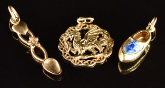 Two 9ct gold charms, one a Welsh dragon and the other a Welsh love spoon (2.9g) and a 14k gold charm