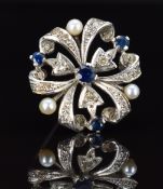 A 9ct white gold brooch set with sapphires, pearls and diamonds, London 1967, 4g, 2cm