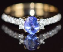 A 9k gold ring set with an oval cut tanzanite and diamonds, 2.3g, size O