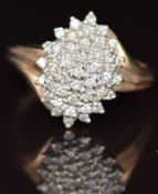 A 9ct gold ring set with diamonds in a cluster, 5.1g, size S