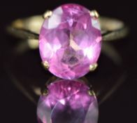 A 9ct gold ring set with an oval pink topaz, 3.1g, size O