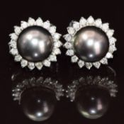 A pair of 18ct white gold earrings each set with a Tahitian pearl measuring approximately 9.4mm