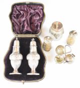 Hallmarked silver peppers and similar condiments to include a cased pair of Victorian peppers,