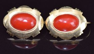 A pair of 18ct gold earrings each set with a coral cabochon, 5.2g