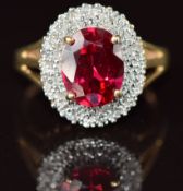 A 9k gold ring set with an oval cut synthetic ruby surrounded by diamonds, 3.6g, size M