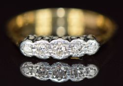 An 18ct gold ring set with five diamonds in a platinum setting, 2.9g, size O