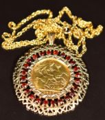 1907 Edward VII gold full sovereign in a 9ct gold pendant mount set with garnets, on 9ct gold chain,