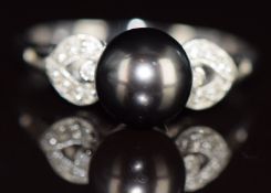 A 14k white gold ring set with a Tahitian pearl measuring approximately 8.4mm and diamonds, 3.8g,