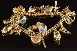 A 9ct gold charm bracelet with seventeen 9ct gold charms including owl, horse, hedgehog, palm