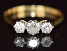 An 18ct gold ring set with three round cut diamonds, the largest approximately 0.3ct, size R/S