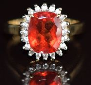 A 9k gold ring set with a cushion cut Tibetan andesine of approximately 1.9ct surrounded by white