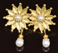 A pair of 18ct gold earrings by Robert Crerar each in the form of a flower set with a split pearl