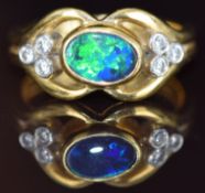 An 18ct gold ring set with a black opal doublet and diamonds, 7.8g, size O