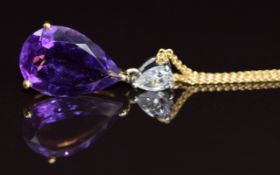 An 18k gold pendant set with a pear cut diamond of approximately 0.25ct and a pear cut amethyst of