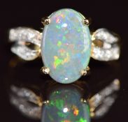 An 18k gold ring set with a Lightning Ridge black opal of approximately 2.2ct and diamonds to the