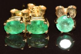 A pair of 18k gold earrings each set with and oval cut emerald of approximately 0.5ct (1.3g) and a