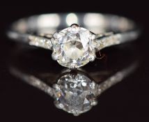 An 18ct gold ring set with a 0.6ct old cut diamond with further diamonds to the shoulders, 2.2g,