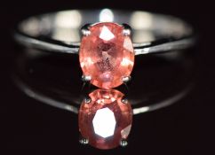 An 18k white gold ring set with an oval Padparadcha sapphire of approximately 0.94ct, 1.7g, size N