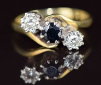 An 18ct gold ring set with a sapphire and two diamonds in a twist setting, 4g, size N