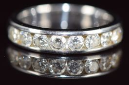 An 18k white gold half eternity ring set with eight round cut diamonds, the total diamond weight