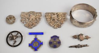 A hallmarked silver nurse's buckle, two silver nursing brooches, Victorian silver brooch with