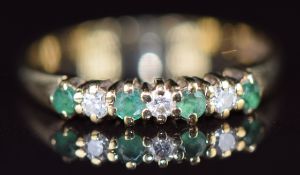 A 9ct gold ring set with diamonds and emeralds, 1.6g, size M