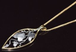 An 18ct gold bi-coloured pendant in the form of ivy (4cm) on 18ct gold chain, 6.7g, 44cm