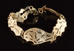 A 9ct bracelet made up of pierced abstract panels forming a dragon, 26.1g, 18cm