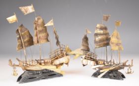 Pair of Chinese or similar silver models of sailing ships or junks, on ebonised bases, height of