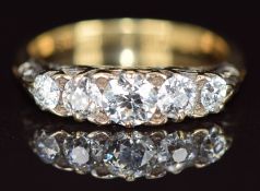 A c1910 18ct gold ring set with five diamonds, the centre diamond approximately 0.4ct, with
