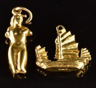Two 14k gold charms, one in the form of a boat the other in the form of a nude lady, 4.7g