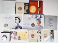 Ten coin packs including stamp covers and a cased pair of crowns, commemorating Elizabeth II