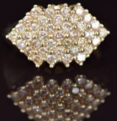 A 9k gold ring set with a cluster of round cut champagne diamonds, 5.7g, size R