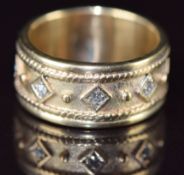 A 9ct gold ring set with five diamonds in diamond shaped settings, 7.8g, size N
