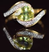 An 18k gold ring set with a pear cut Capelinha sphene and diamonds in a twist setting, 2.9g, size N