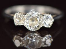 A platinum ring set with three old cut diamonds of approximately 0.8ct, 0.2ct and 0.2ct, 3.1g,