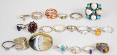 Twenty silver rings including tiger's eye, garnet, amethyst, pearl and turquoise, etc and a large