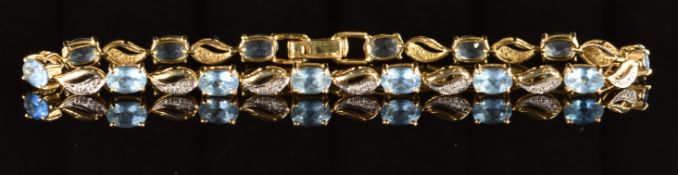 An 18k gold bracelet set with fourteen oval cut Santa Maria aquamarines, the total weight