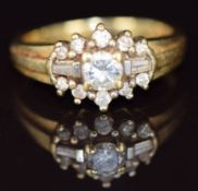 An 18ct gold ring set with round and baguette cut diamonds, 4.9g, size L