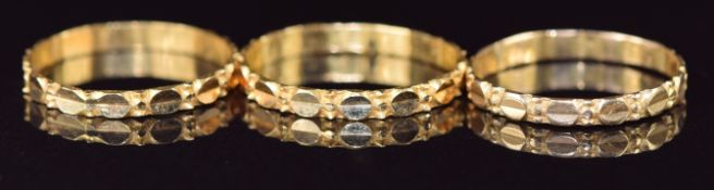 Three yellow metal rings, testing as 21k, 4.8g, size Q